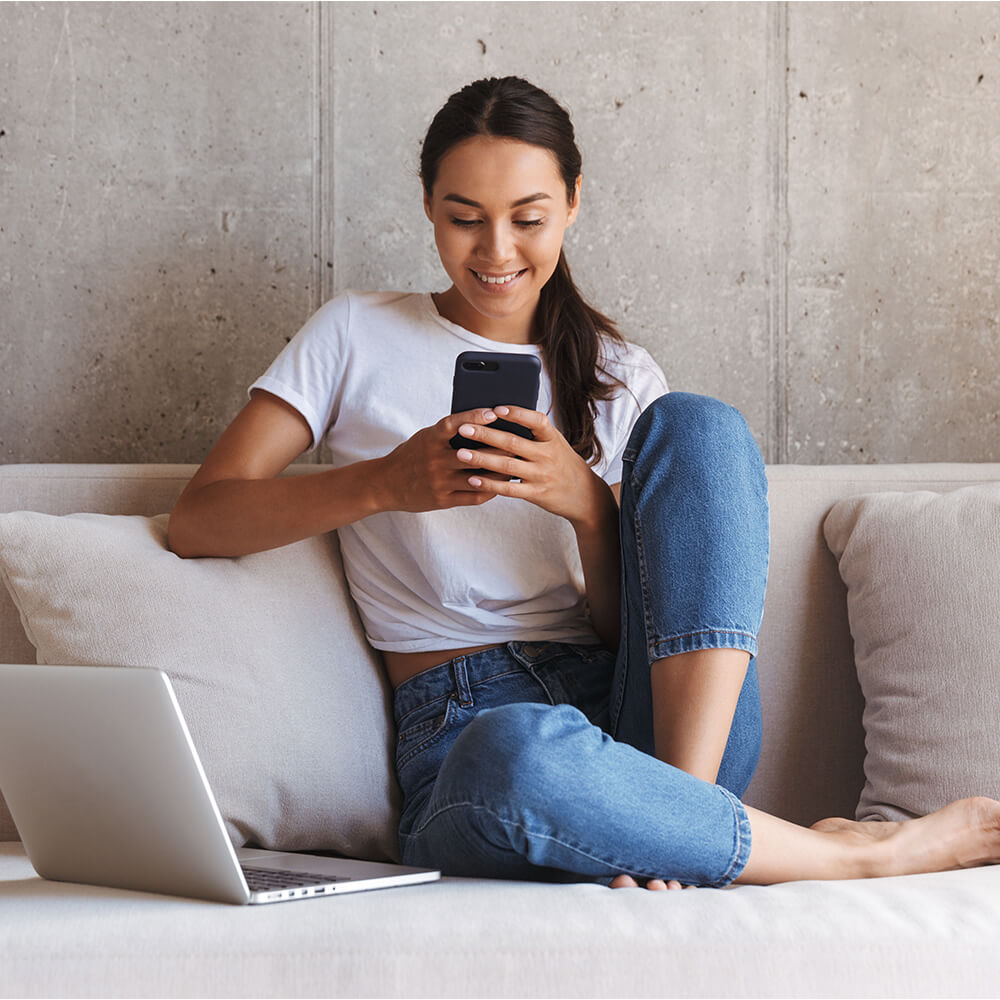 young woman on phone on sofa