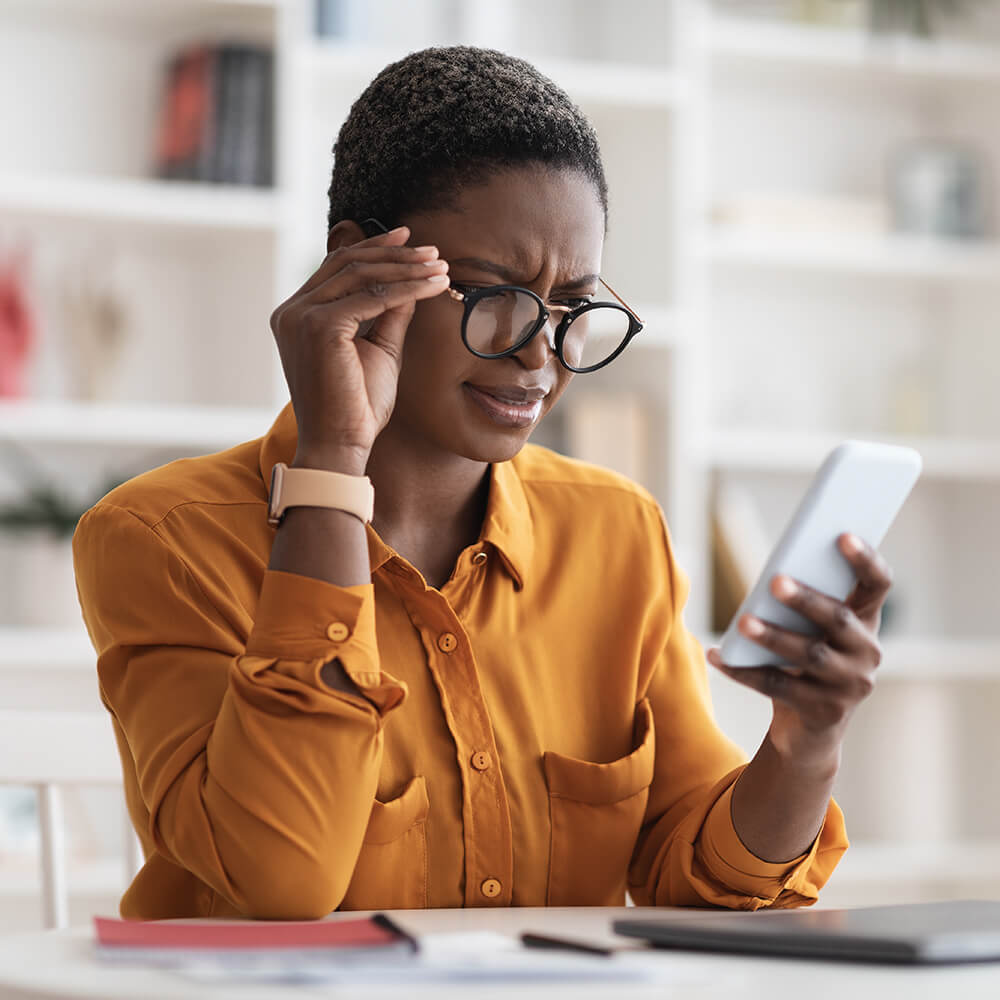 woman looking closely at phone