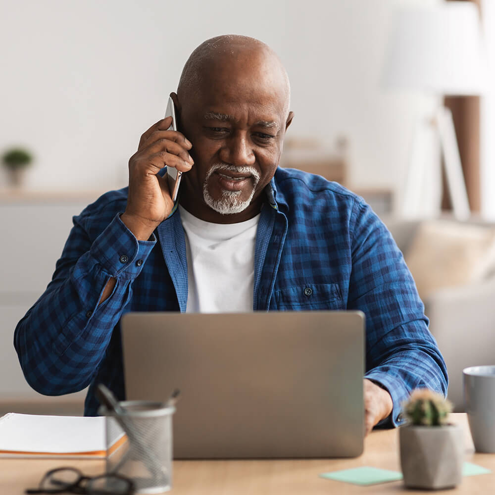older man on laptop whist on a call
