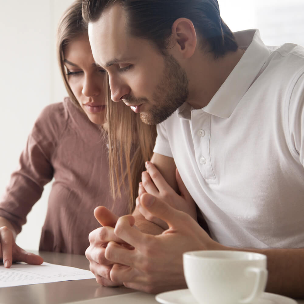 mid-close-up of man and women reading over a document