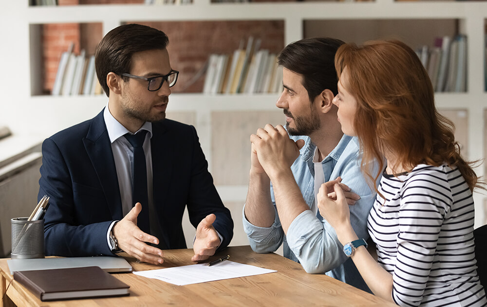 couple talking to a business man