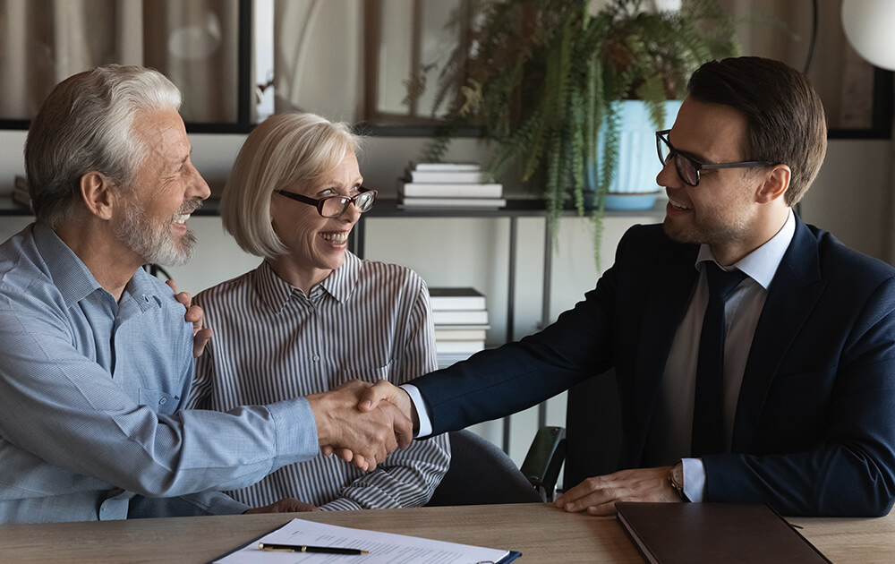 older man shaking hand with younger business man