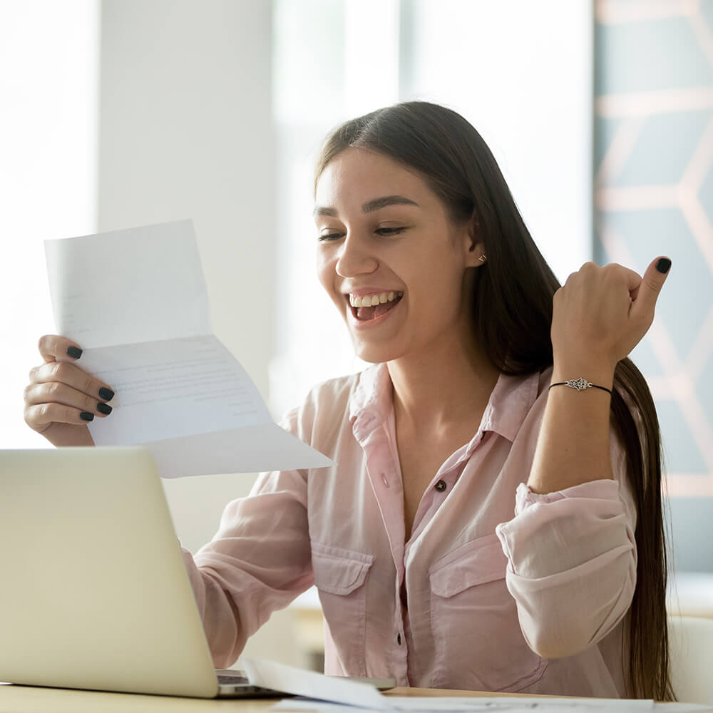 women smiling at letter