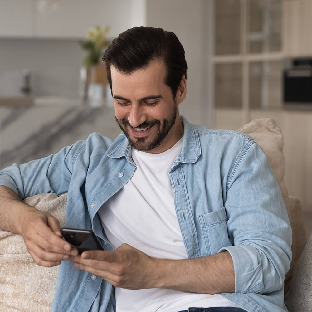 man smiling at phone