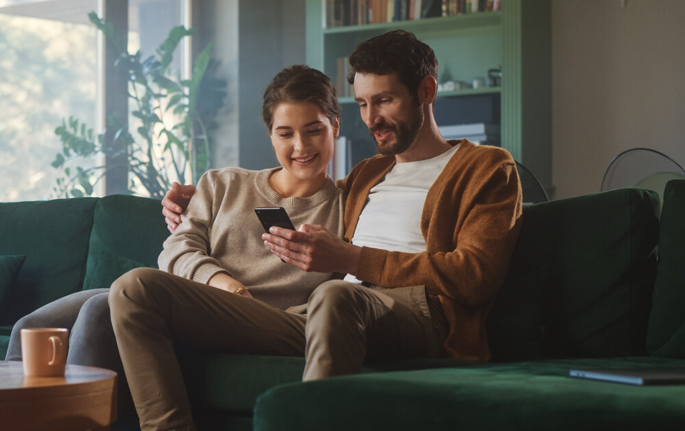 couple smiling at phone