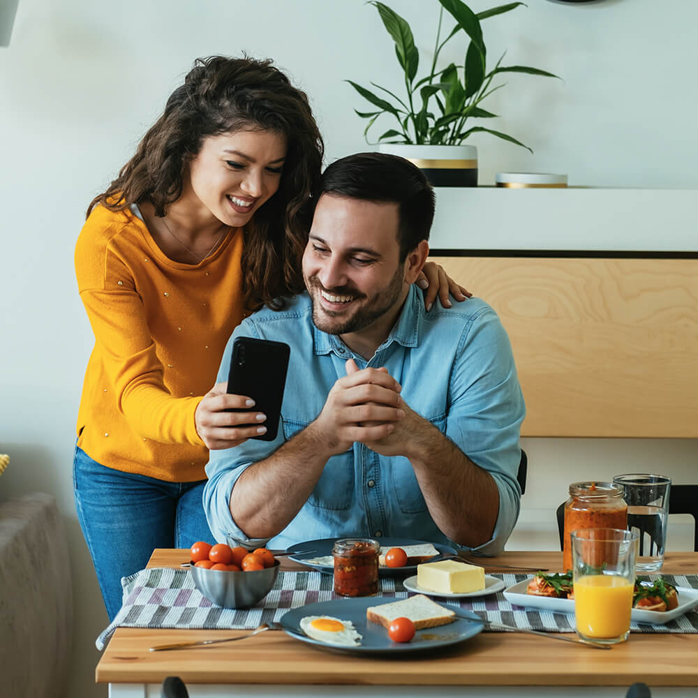 couple smiling at phone