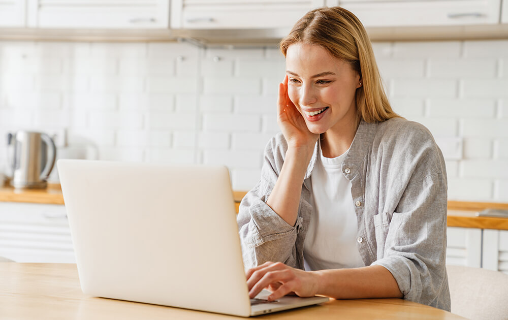 woman on laptop in kitchen