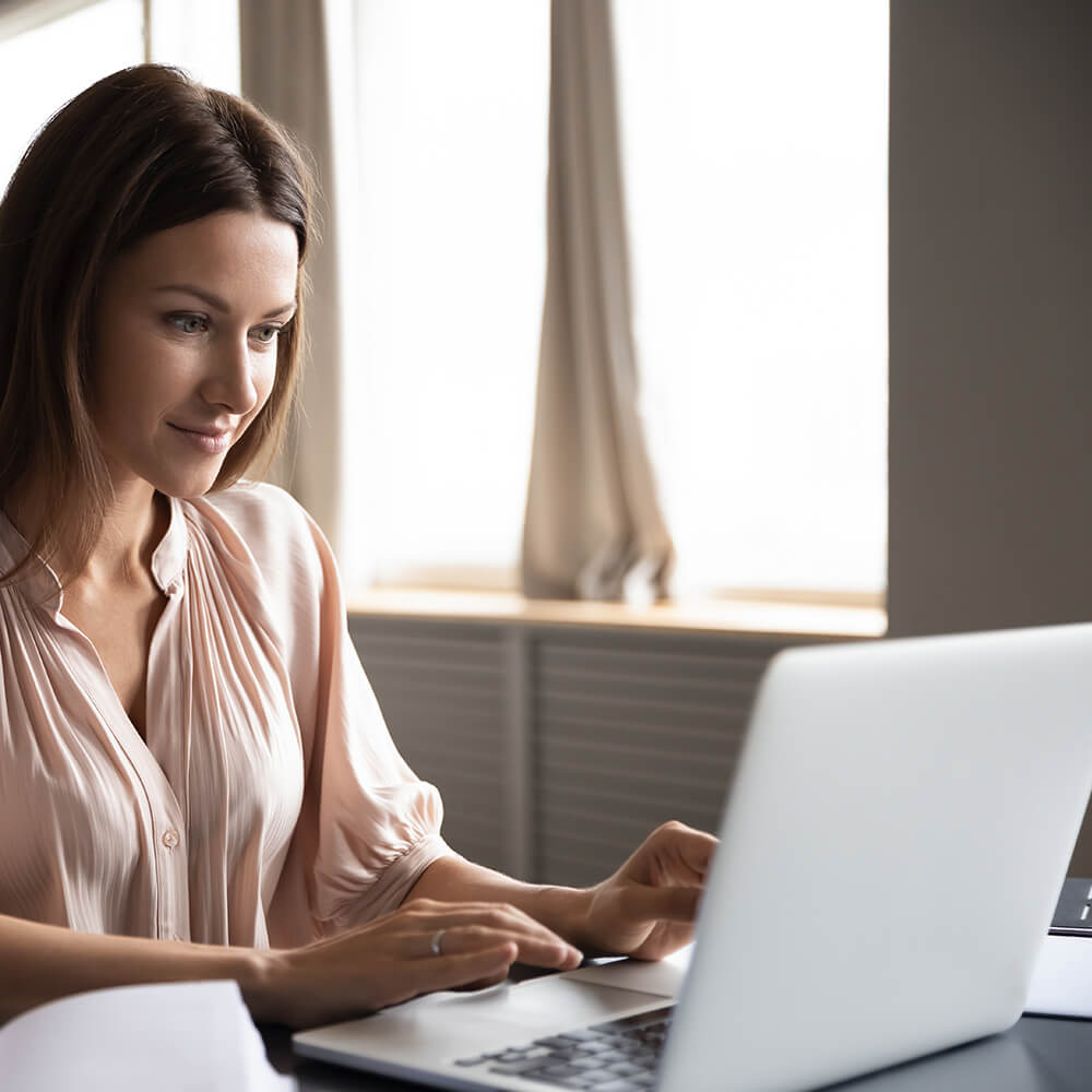 woman on laptop at a table