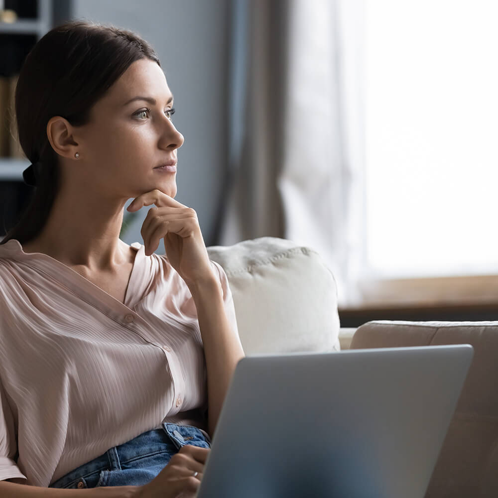 woman zoning out into the room