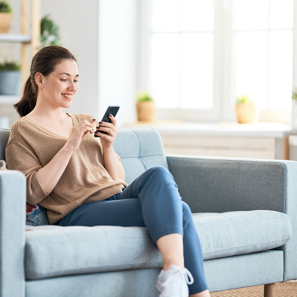 woman applying for loan on her sofa