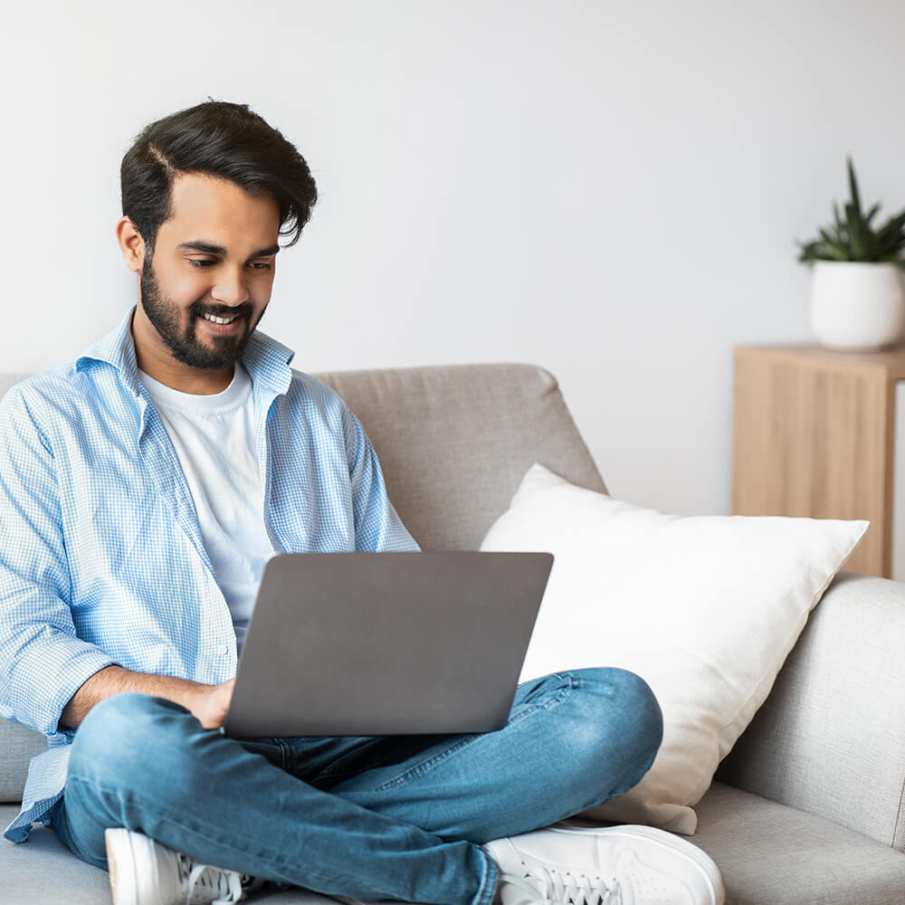 man smiling at laptop