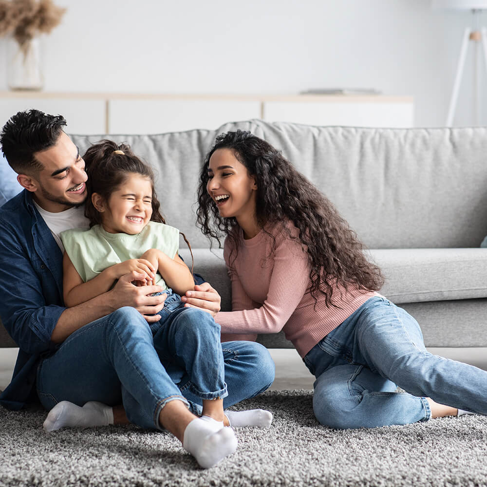 family smiling and holding each other
