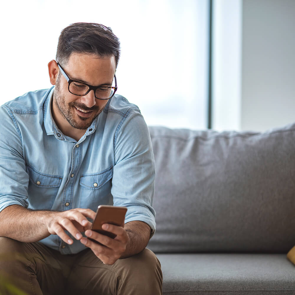 man smiling at phone