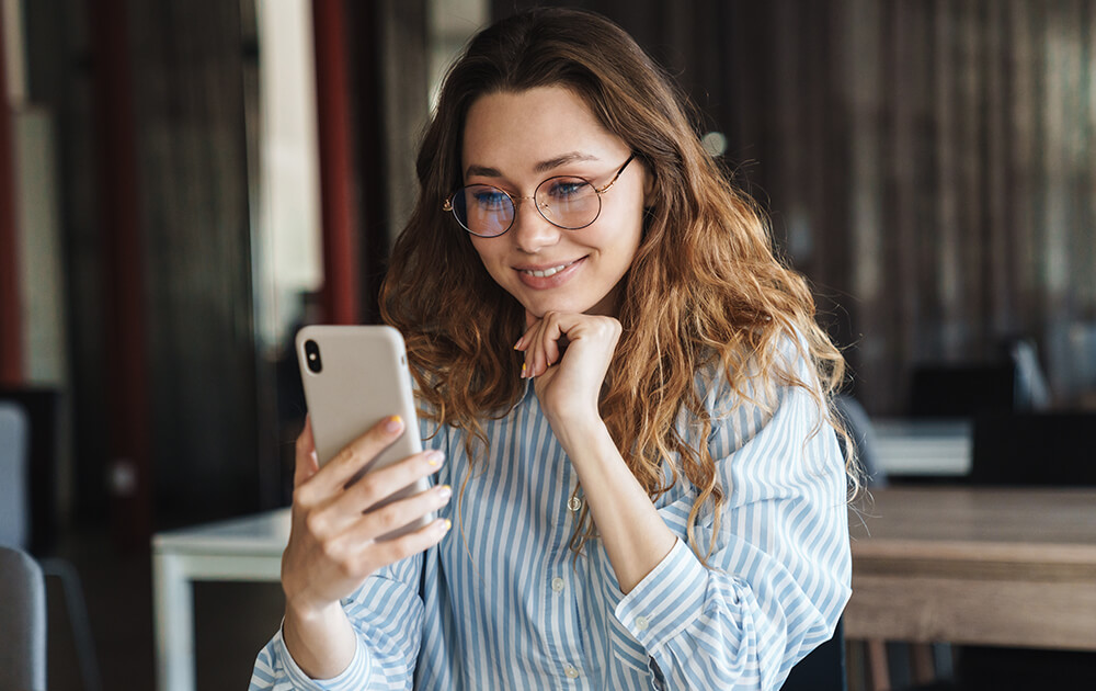 woman smiling at phone