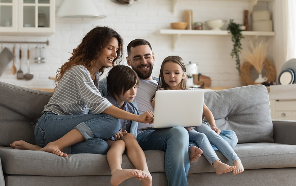 family looking at laptop