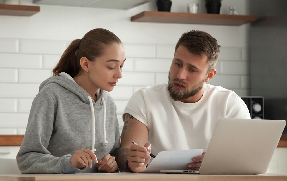 couple talking and reading over papers