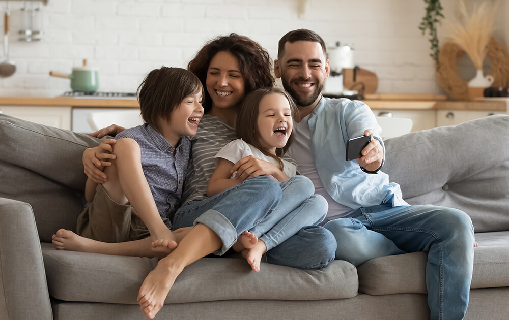 couple smiling and laughing on a sofa