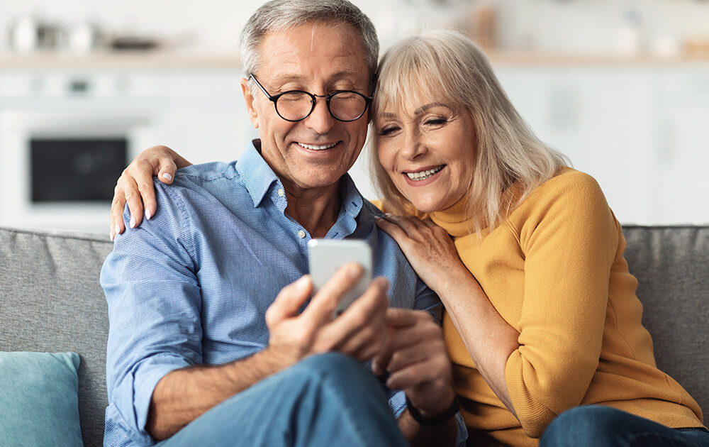 couple smiling at phone