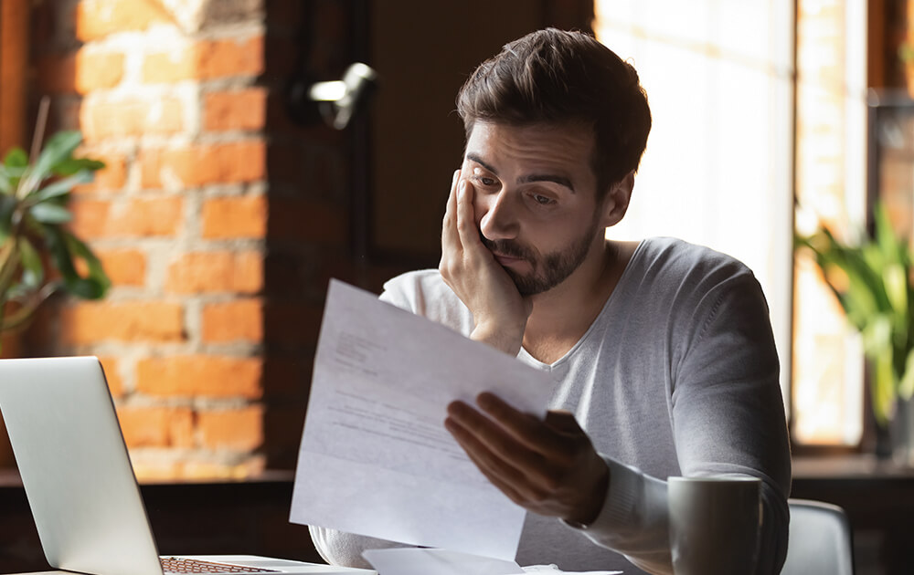 man stressed out over papers