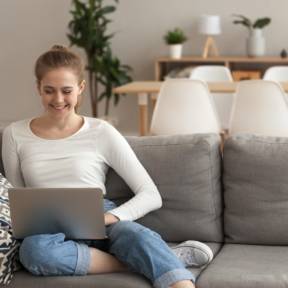 woman on laptop on sofa